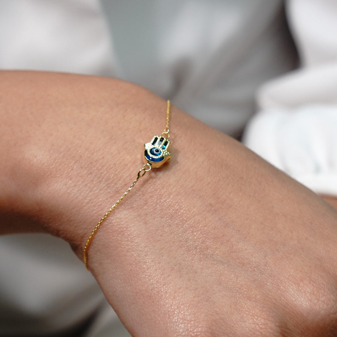 HERSHE, Evil Eye Hamsa Bracelet in 14 Karat Solid Gold.